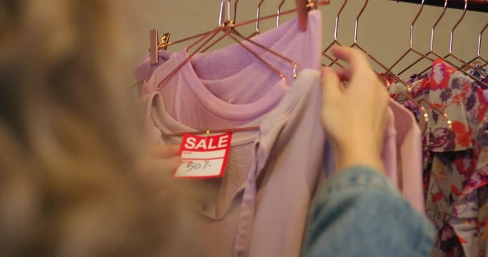 CU MS TS SELECTIVE FOCUS Women choosing clothing in boutique at King's Cross / London, UK