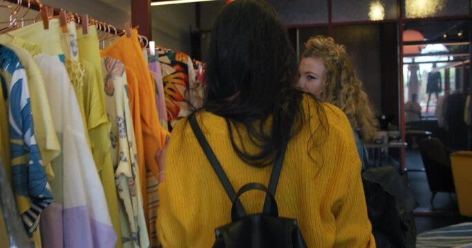 MS TS Women choosing clothing in boutique at King's Cross / London, UK
