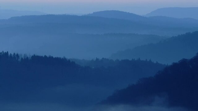 WS Aerial view of fog in mountains at twilight / Mettlach, Saar Valley, Saarland, Germany