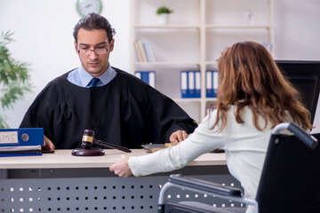 Injured woman and male judge in the courtroom