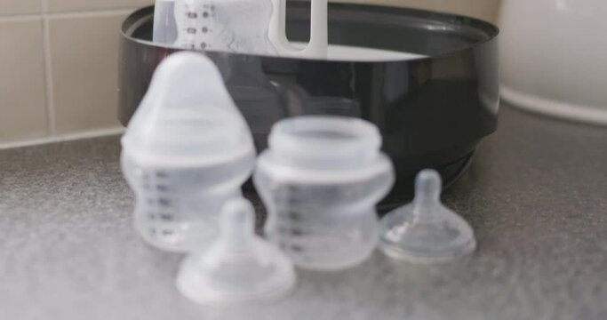 Close up of baby bottles and sterilizing equipment.