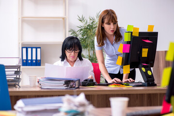 Two female employees and excessive work in the office