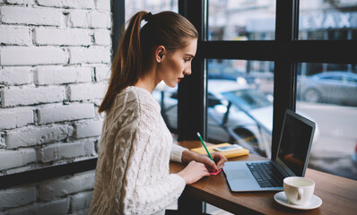 Talented linguist making notes on stickers for better memorise new words