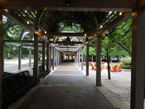 Covered Walkway In Park With Tables And Chairs And Lighting