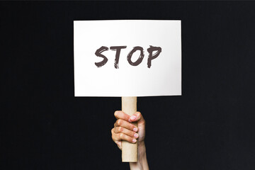 activist with a stop poster. protest banner on black background
