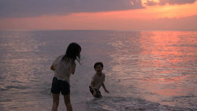 Holiday concept. Children playing in the sea. 4k Resolution.