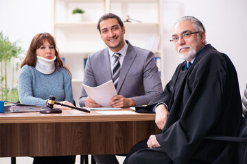 Young woman in courthouse with judge and lawyer