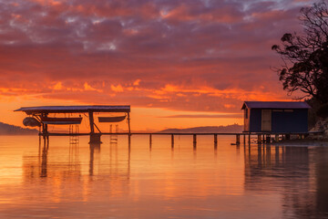 Beautiful winter's sunrise over Coningham Boat Shed.North West Bay.South East Coast of Tasmania,Australia.