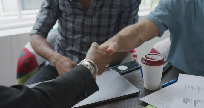 CU SLO MO Business people shaking hands during meeting in office / Soho, London, England, United Kingdom - Powered by Adobe