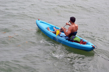 Maan paddling in an inflatable kayak on Biscayne Bay near Miami Beach,Florida