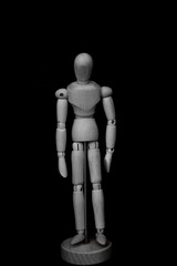 wooden mannequin standing on black background with feeling dowm posture