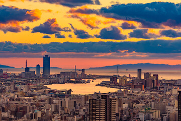 Japan. Osaka. View of Osaka Bay at sunset. Evening panorama of Osaka from a height. Island of Honshu. The urban landscape of Japan. Urbanistics. Modern buildings in Japan. Picturesque sunset in Japan.
