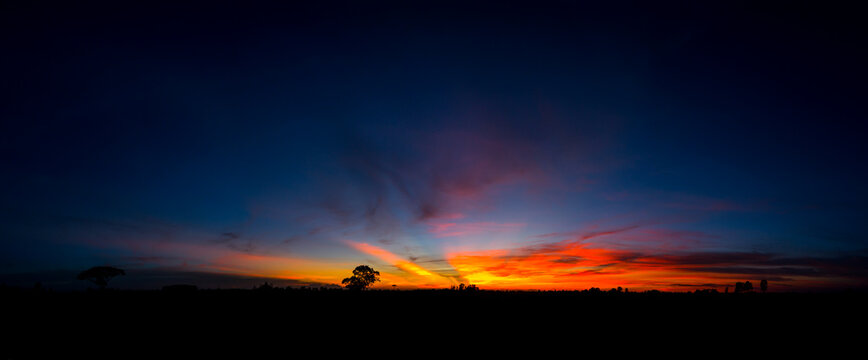 Panorama  beautiful Sunset with dramatic sky clouds.Sunrise with cloud over rice field.Vivid sky on dark clouds.Long shots photo background for use.