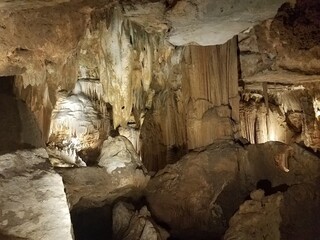 Fototapeta na wymiar brown stalactites and stalagmites in cave or cavern
