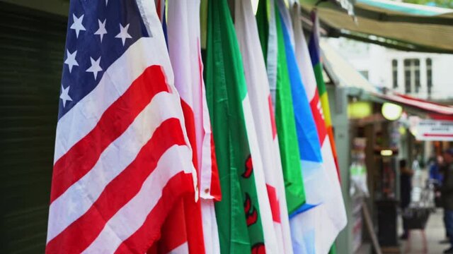 Close up of national and international flags outside Norwich market, England.