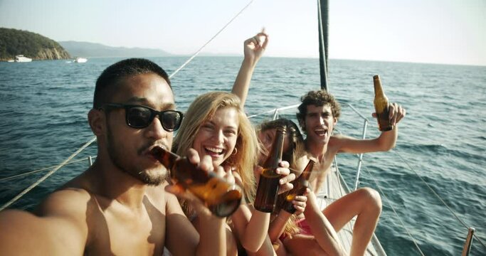 Group of young friends enjoying trip on a sailboat in the Ligurian Sea.