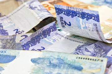 various Brazilian money notes, dirty and fallen on the floor. Disorganized finance or financial crisis concept