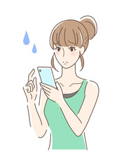 スマホを操作して不安な女性