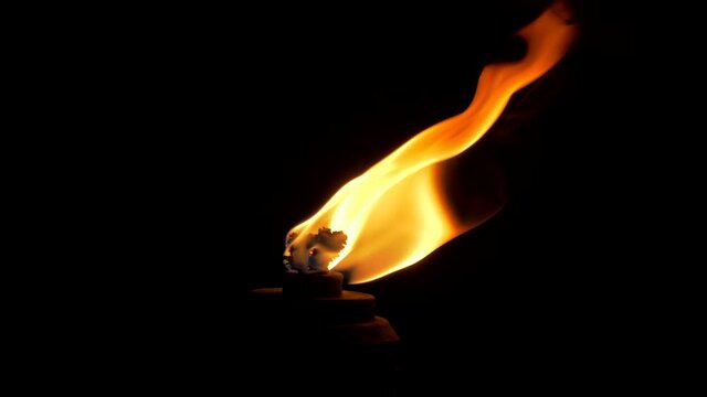 Flame of a burning torch in the dark. Flaming Torch Isolated in Pitch Black Darkness.
