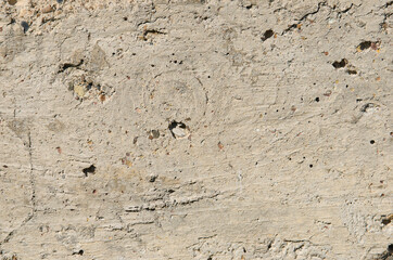 The texture of the wall is cement mixed with small stones.
