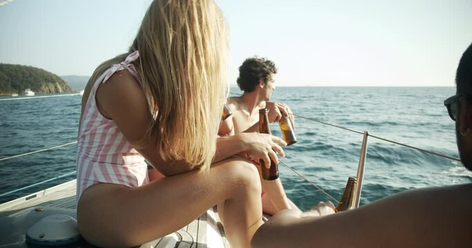 Group of young friends enjoying trip on a sailboat in the Ligurian Sea.