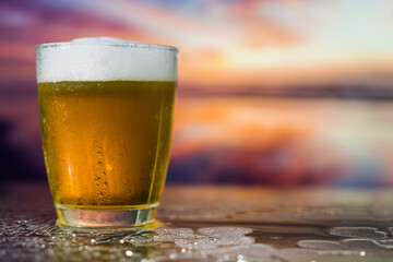 Glass of beer on a sunset