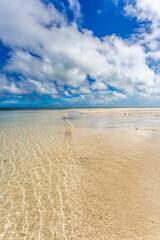 Fototapeta na wymiar Ocean ripples, white sand beach and blue sky