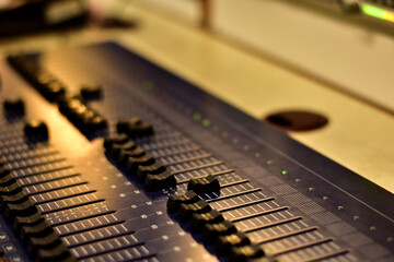 Closeup Analog sound mixer with selected focus. Professional audio mixing console broadcasting.