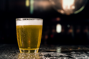 Beer glass on the bar counter.