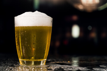 Beer glass on the bar counter.