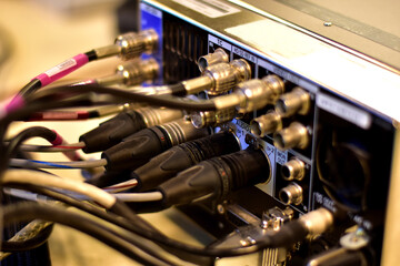 Closeup of Audio Cable Jack for connected to the rear panel of high-quality audio equipment in control room.