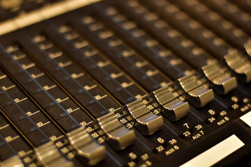 Closeup Analog sound mixer with selected focus. Professional audio mixing console broadcasting.