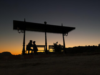 romantic couple dating at sun set point
