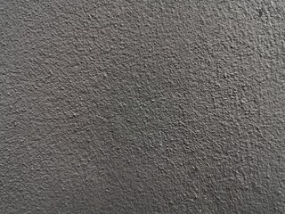 Glossy Black Concrete Wall. Rough surface of the cement wall