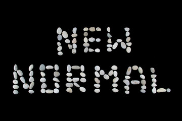 Word New Normal concept on black color background with copy space made of stone