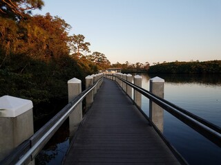 Obraz na płótnie Canvas boardwalk or trail with railing and water in lake