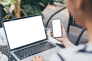 computer,cell phone mockup image.hand woman work using laptop texting mobile.blank screen with white background for advertising,contact business search information on desk in cafe.marketing,design