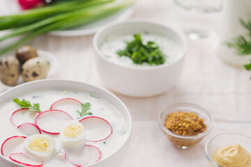 
Traditional summer cold soup in white bowls on the table. Easy vegetable dishes.