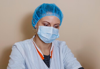 A female doctor in a sterile mask and uniform on prevention during the covid-19 coronavirus pandemic