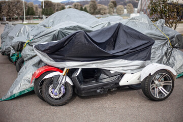 The motorcycle is covered with an awning.