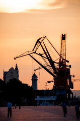 China, Heihe, July 2019:sunset landscape, construction cranes on the Amur river embankment in Heihe in summer