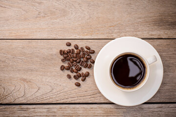 White cup of black coffee on wooden table background. Top view, Flat lay. 