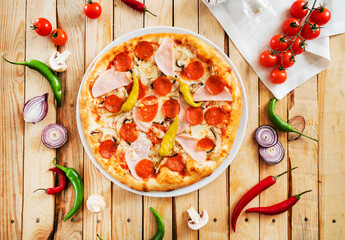 tasty pizza on the wooden background