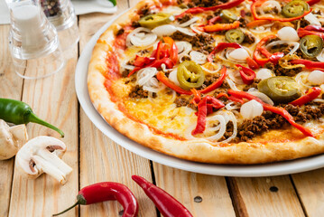 tasty pizza on the wooden background