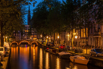 Amsterdam canal shimmers at twilight