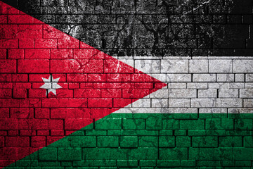 National flag of Jordan on brick  wall background.The concept of national pride and symbol of the...