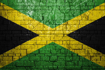 National flag of Jamaica on brick  wall background.The concept of national pride and symbol of the...