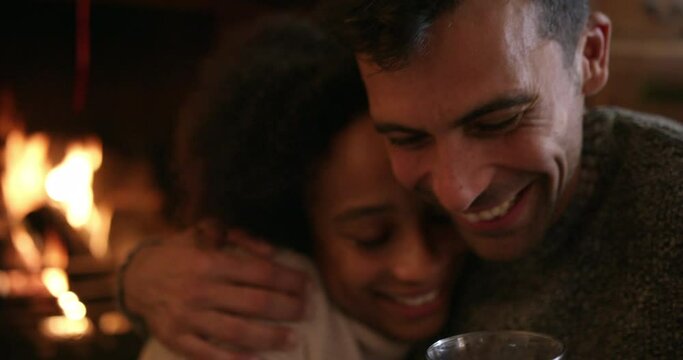 CU HANDHELD Smiling couple embracing and enjoying red wine near Christmas tree and fireplace / Dinton, Wiltshire, United Kingdom