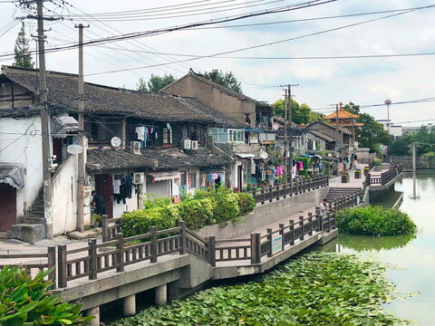 local street of chinese village with simple smart houses and view on the green river