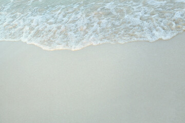 Fototapeta na wymiar Soft focus and tone of wave sea on the sandy beach.Summer vacation background.